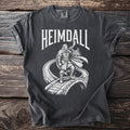Heimdall graphic t-shirt with Viking warrior blowing horn on arched bridge.
