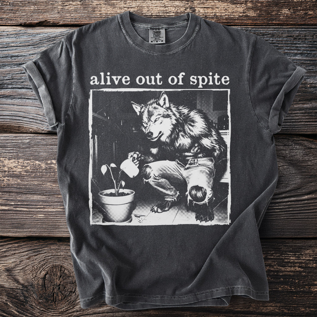 Dark gray t-shirt with "alive out of spite" and wolf watering a plant graphic.