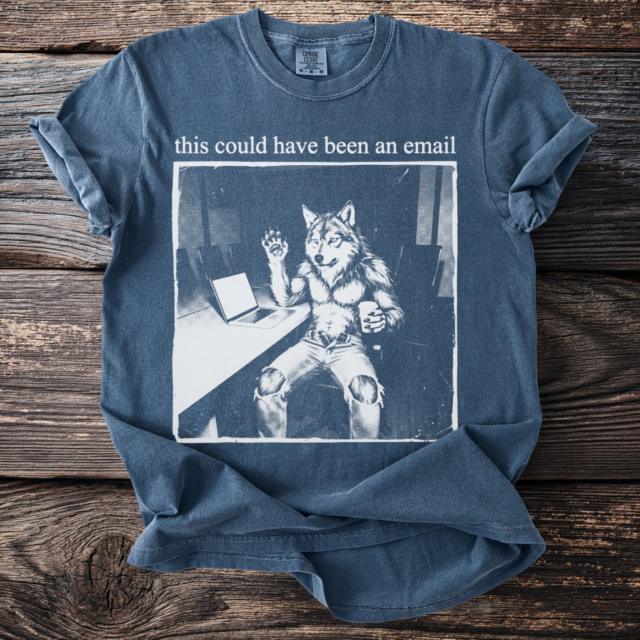 T-shirt with wolf-like character at a desk, text "this could have been an email".