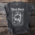 Dark t-shirt with "Black Shuck" and demonic dog graphic, "One Night at St. Mary's Bungay" text.