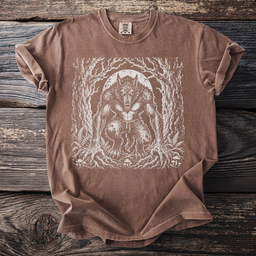Brown Comfort Colors t-shirt with white werewolf forest moon graphic.