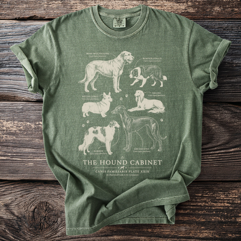 Olive green t-shirt featuring illustrations of six dog breeds with their names and scientific names.