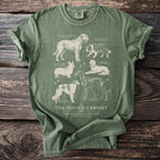 Olive green t-shirt featuring illustrations of six dog breeds with their names and scientific names.