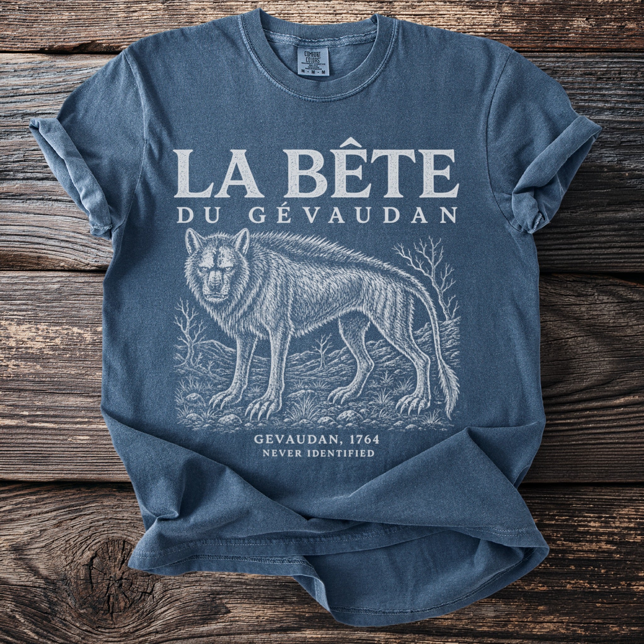 Blue t-shirt with "LA BÊTE DU GÉVAUDAN" and a wolf illustration.