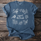 Blue t-shirt with white line art of birds, branches, and the text "respect the locals".