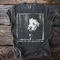 Dark grey t-shirt with white graphic of a dog's face peering through slats and text "please do not perceive me".