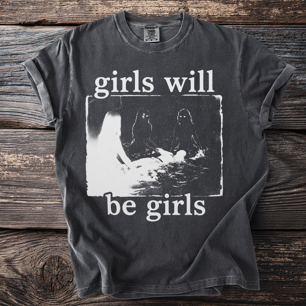 Dark grey t-shirt with white text "girls will be girls" and a distressed graphic.