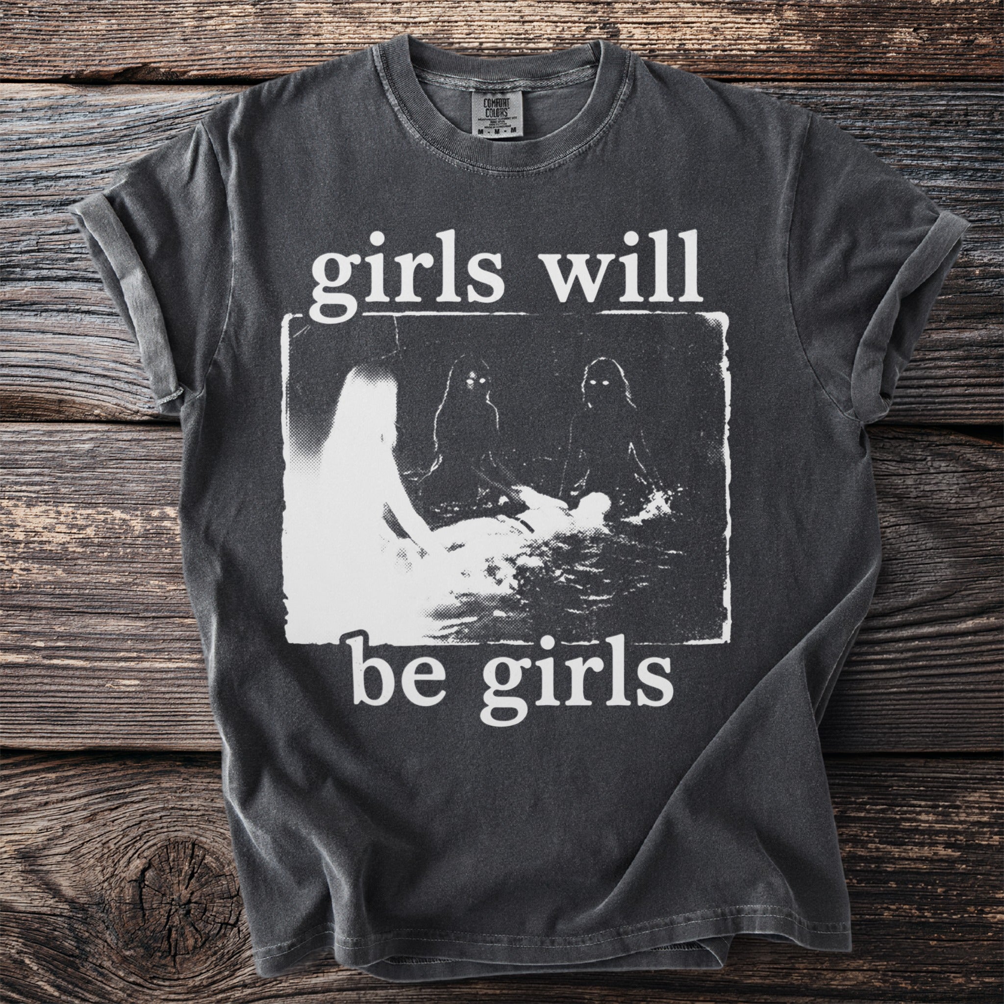 Dark grey t-shirt with white text "girls will be girls" and a distressed graphic.