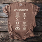 Brown t-shirt with "WITCH SYMBOLS" and grid of symbols with descriptions.