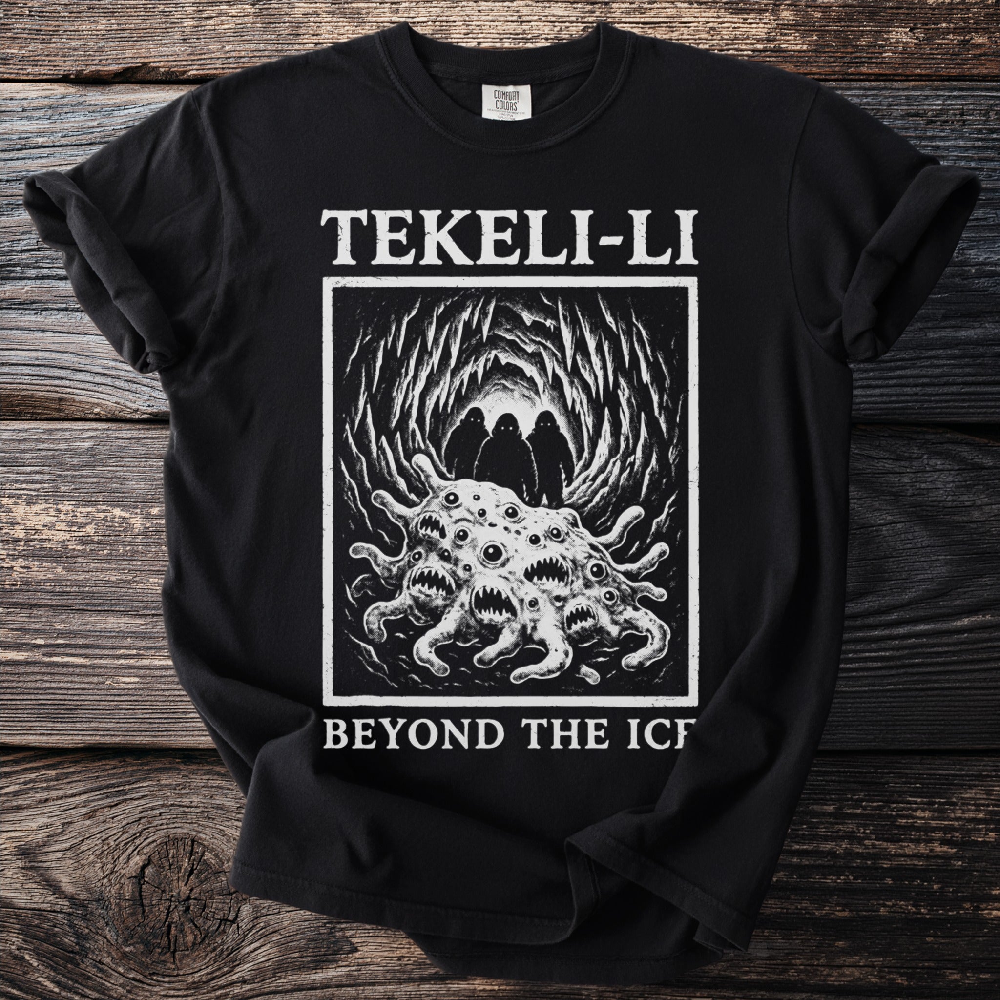 Black t-shirt with "TEKELI-LI BEYOND THE ICE" text and an illustration of a creature.