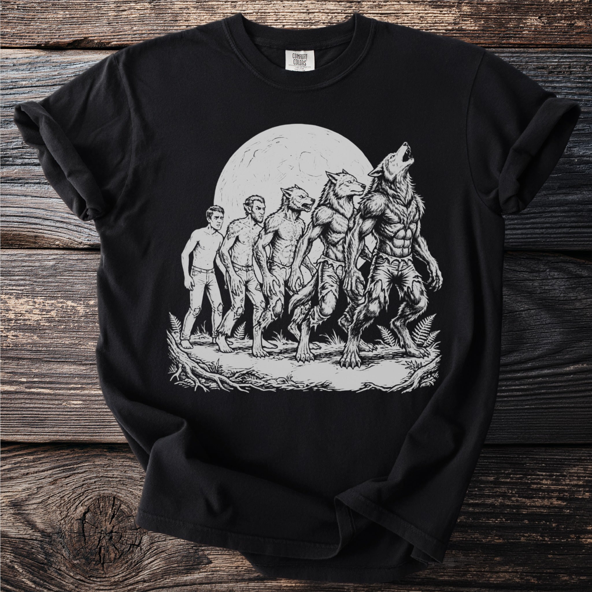 Black t-shirt with a graphic depicting the stages of a werewolf transformation under a full moon.