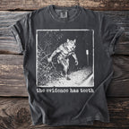 Dark t-shirt with graphic of a werewolf and text "the evidence has teeth."