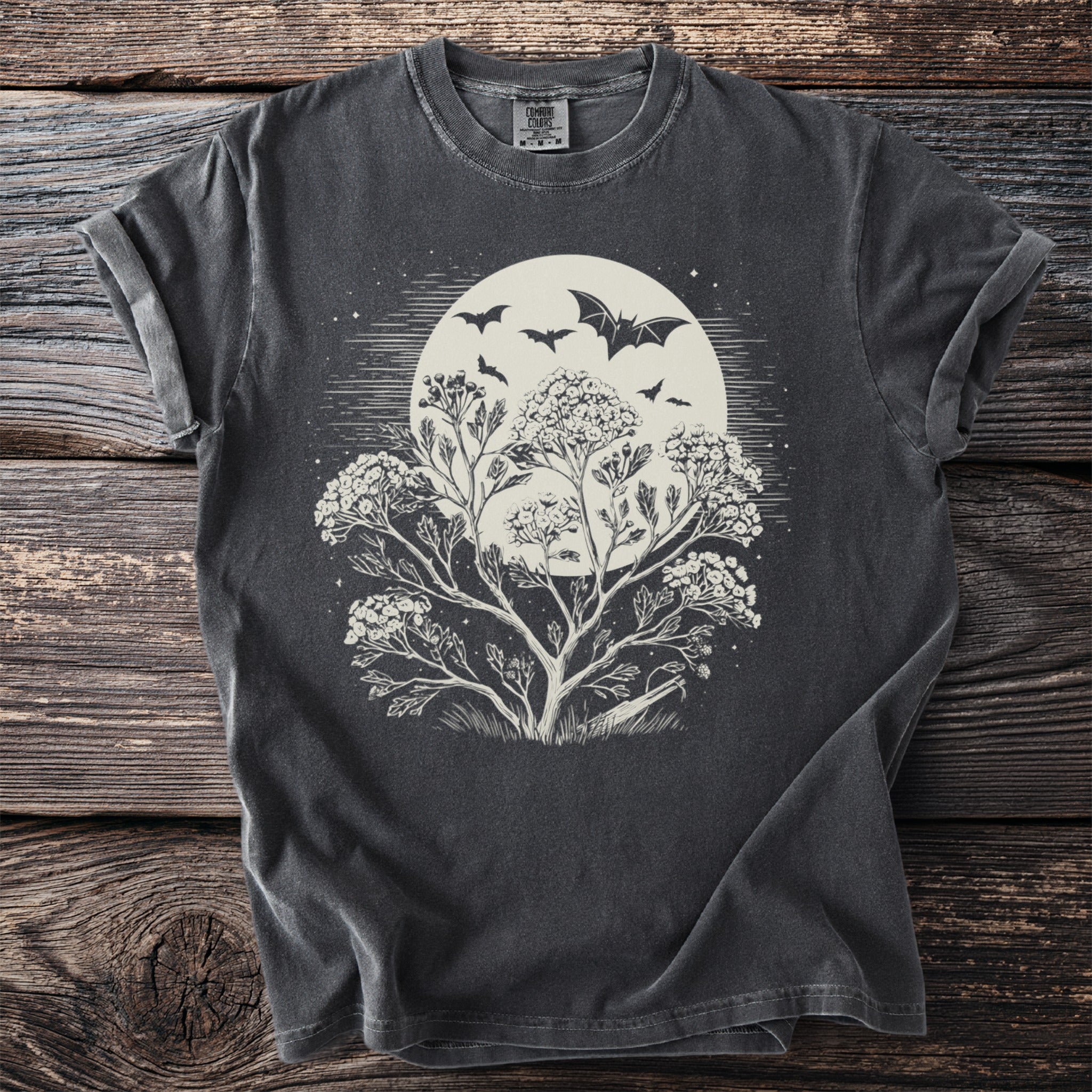 Dark grey t-shirt with a moon, bats, and floral branches design.