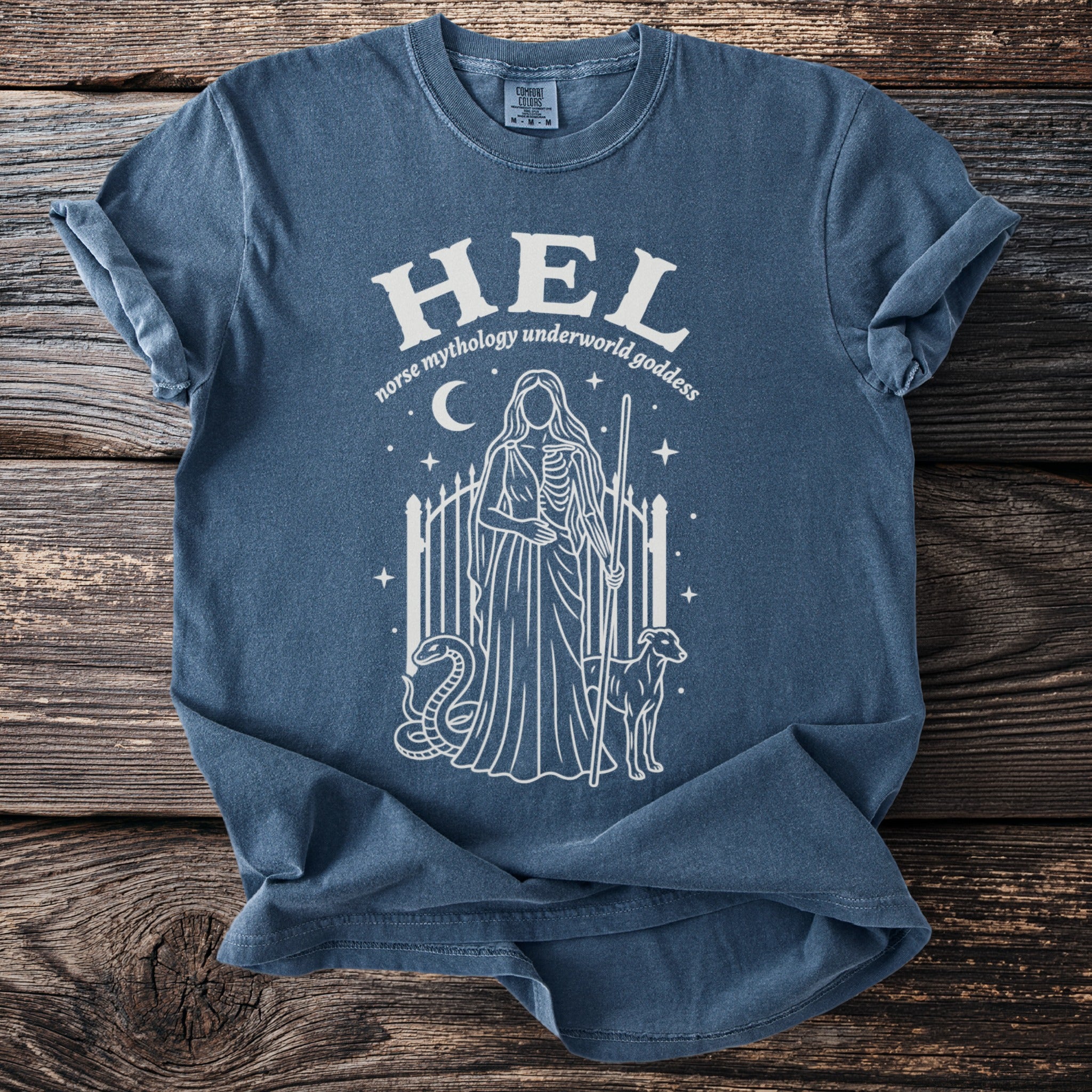 Blue t-shirt with white graphic of Hel, Norse underworld goddess, with snake and dog.