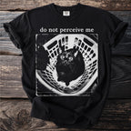 Black t-shirt with "do not perceive me" text and a wide-eyed black cat in a laundry basket.