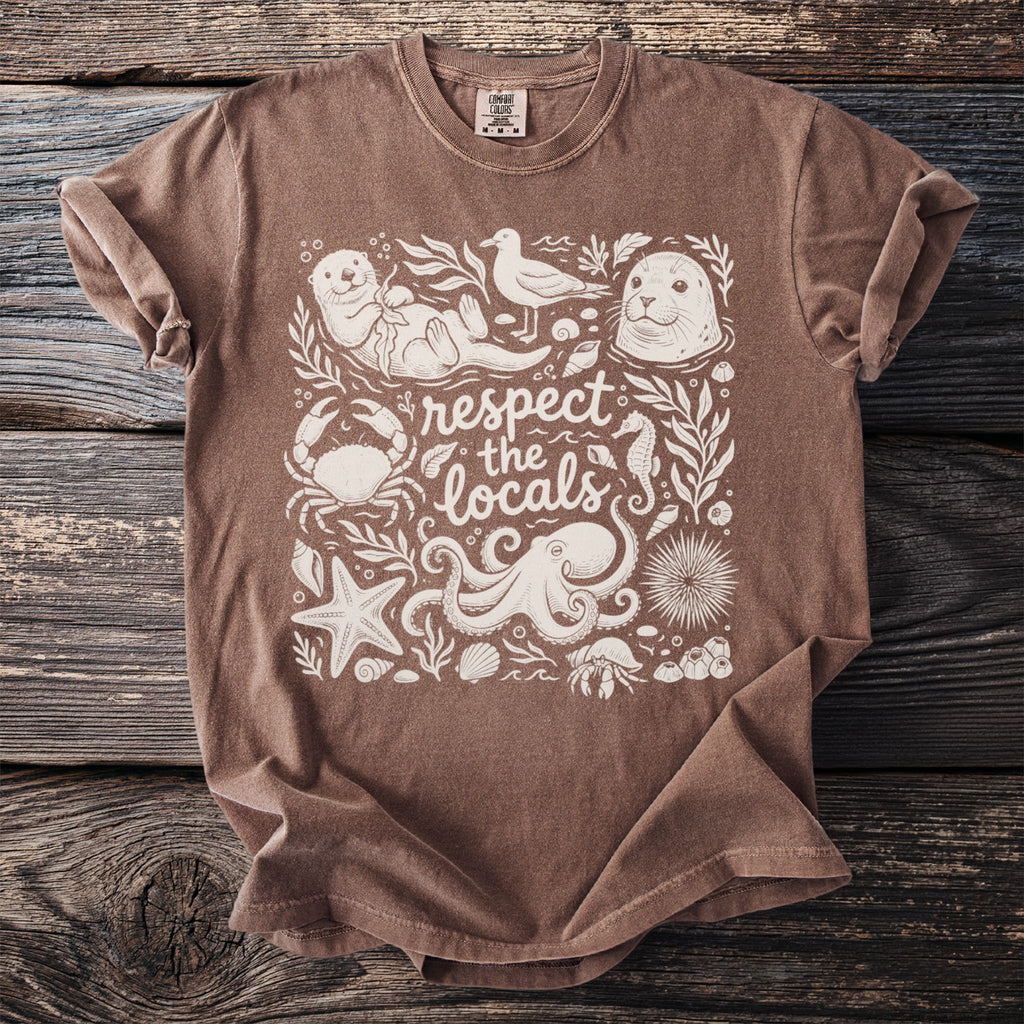 Brown t-shirt with white graphic of "respect the locals" and various sea creatures.