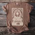 T-shirt with a light brown comfort colors tag and a mystical scene graphic.