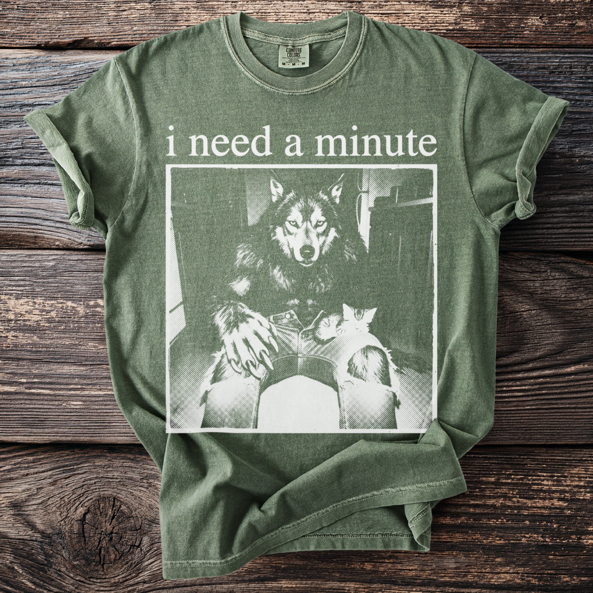Green t-shirt with "i need a minute" text and werewolf holding kittens graphic.