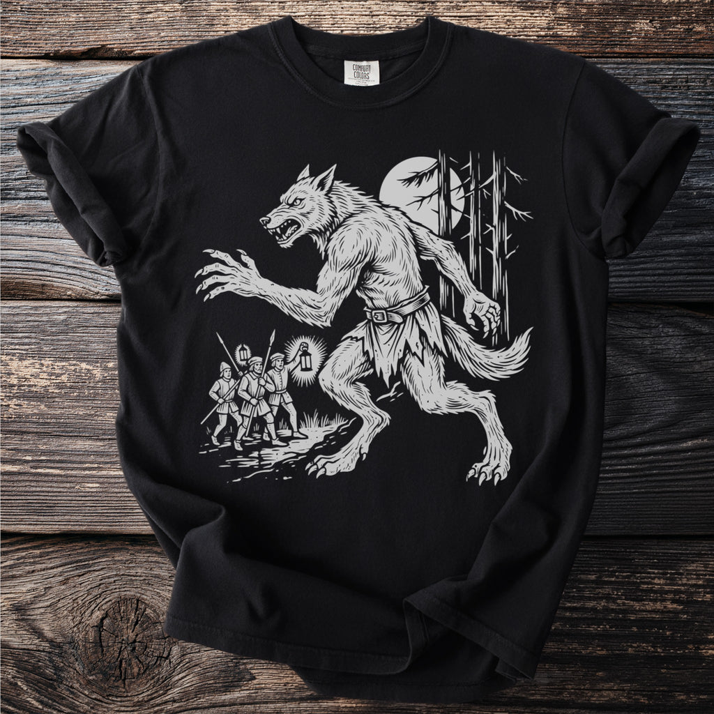 Werewolf running from men with lanterns in a forest scene on a black t-shirt.