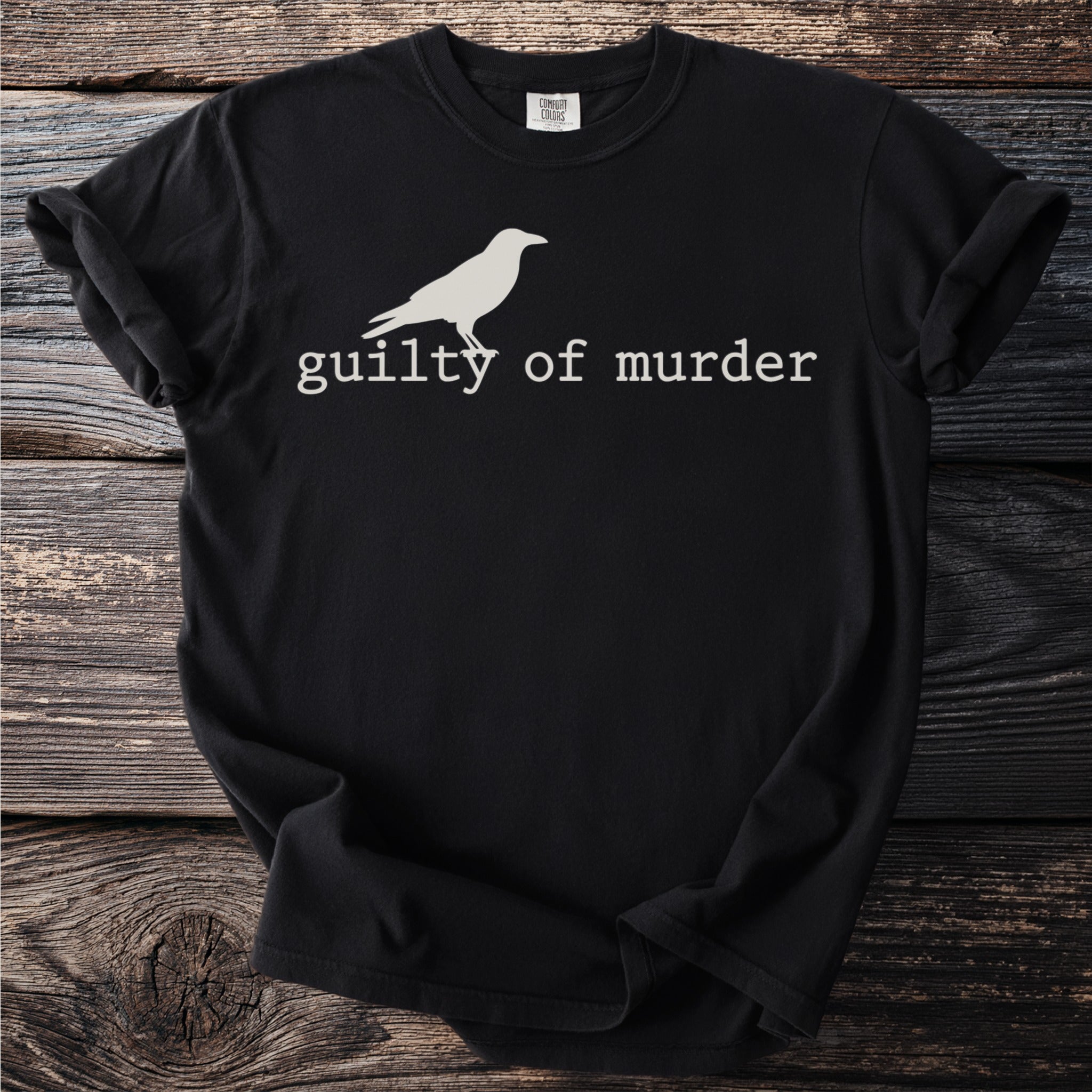 Black t-shirt with white bird and "guilty of murder" text.