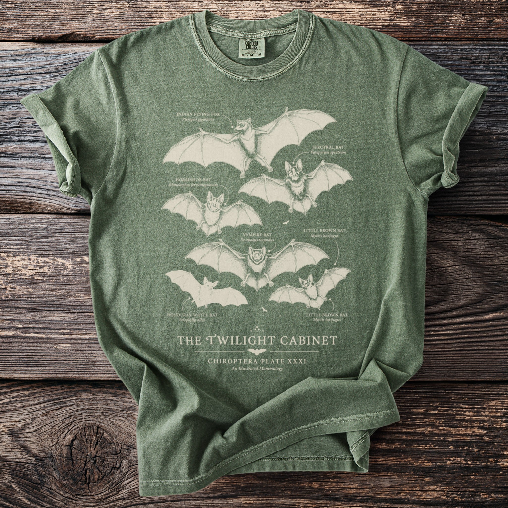 Green t-shirt with illustrations of bats and their names, titled "The Twilight Cabinet".
