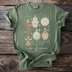 Green t-shirt featuring protective talismans: Khamsa, Cornicello, Vegvisir, Berehynia, Nazar, Witch Bottle.