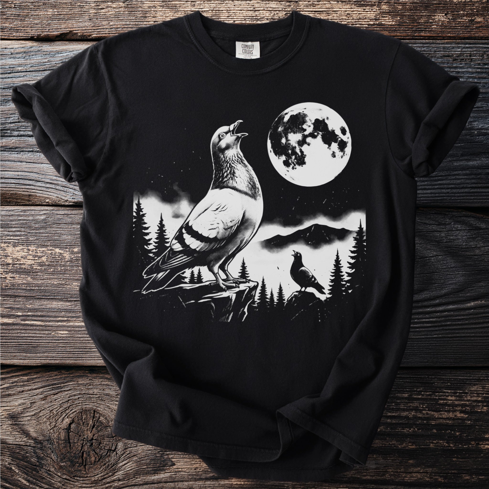 Pigeon and moon graphic on a black Comfort Colors t-shirt.