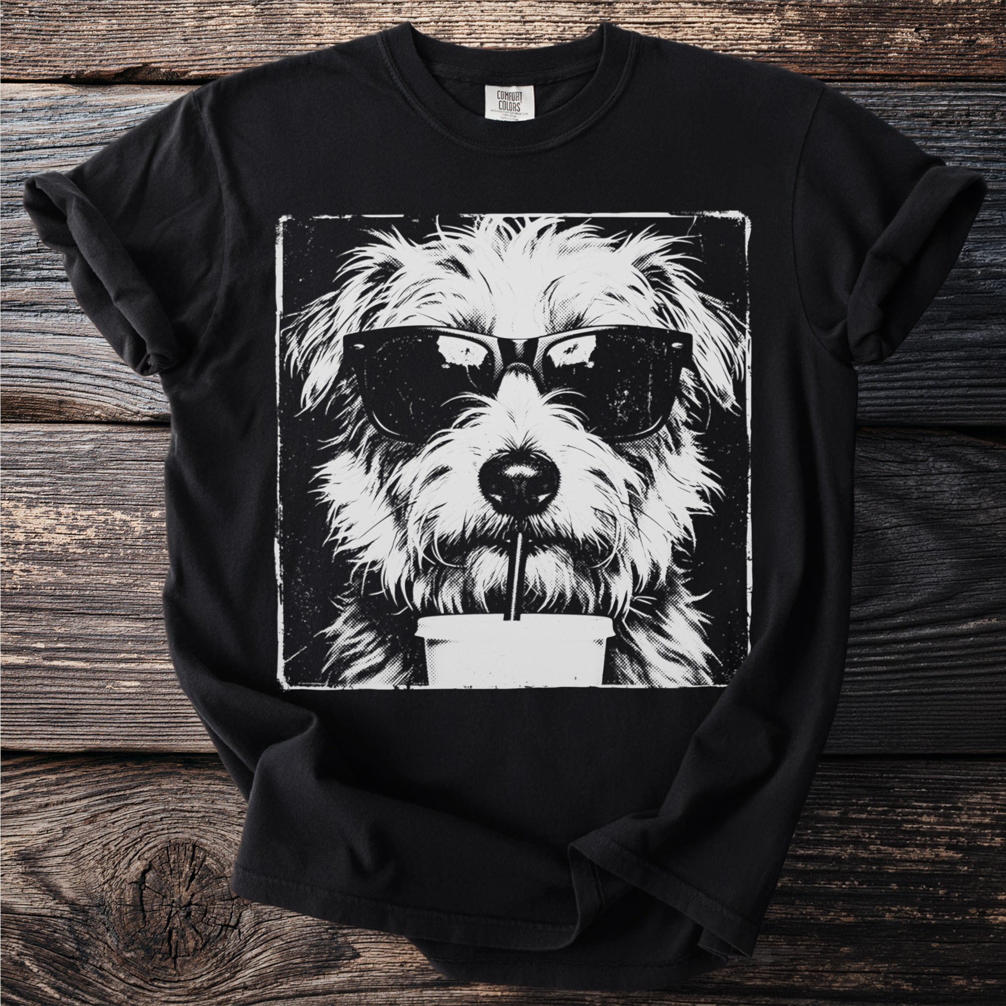 Black t-shirt with a grunge style illustration of a dog wearing sunglasses and drinking from a cup.