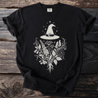 Black t-shirt with a white witch hat, moon, stars, and botanical illustration.
