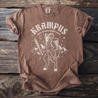 Brown t-shirt with Krampus graphic and text "alpine christmas folklore demon".