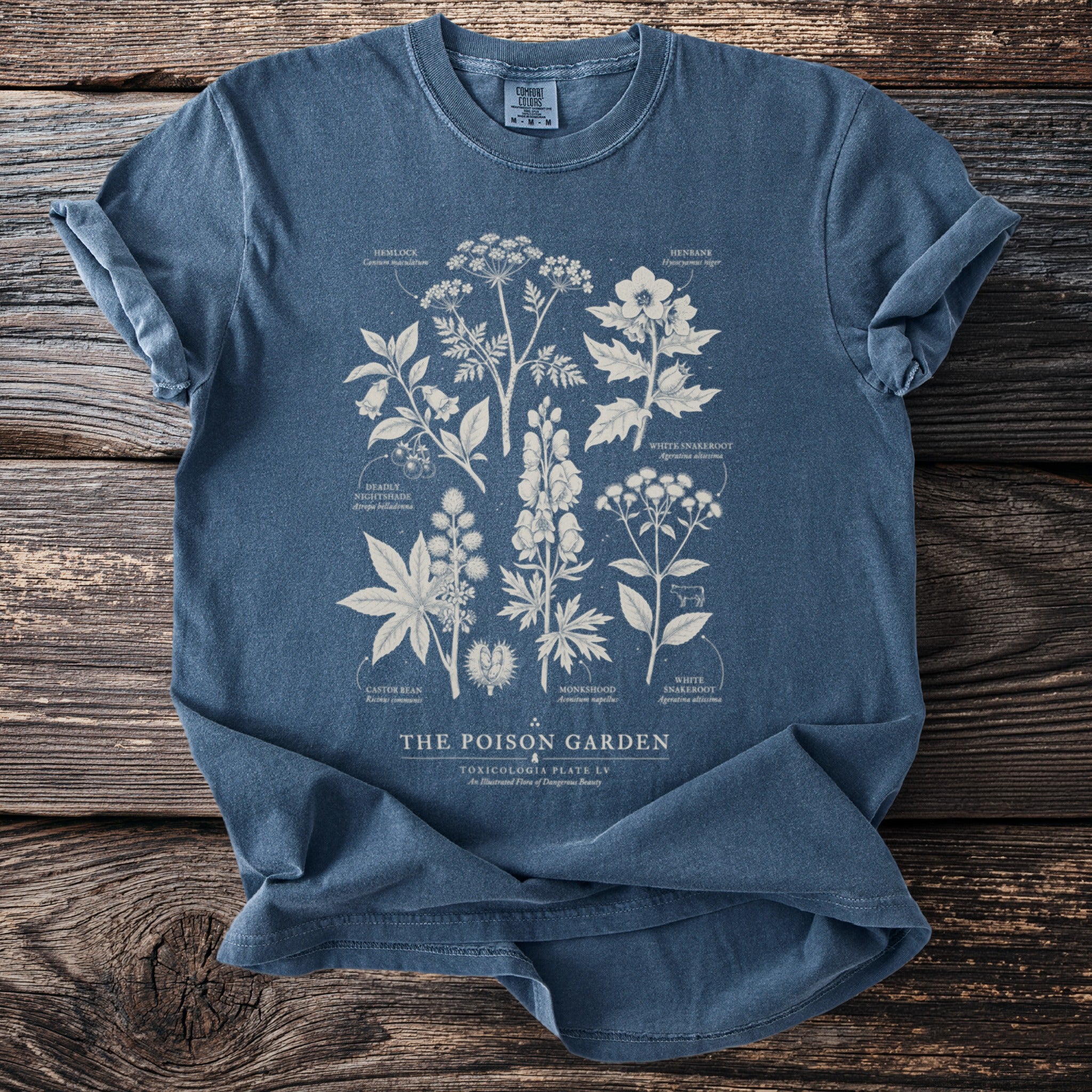 Vintage style blue t-shirt with poisonous plants illustration and text 'The Poison Garden'.