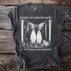 Dark t-shirt with surreal forest design "protect our national parks or we'll haunt your backyard"