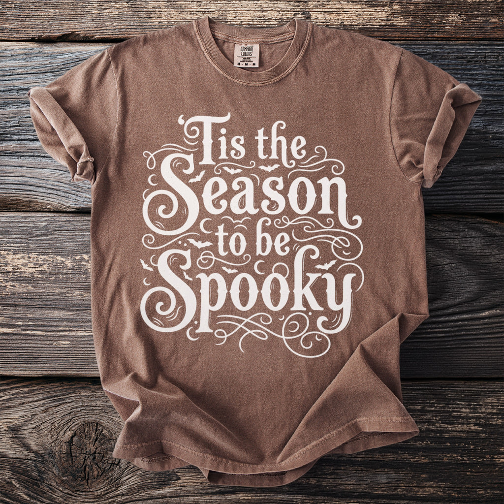 Brown t-shirt with white text "Tis the Season to be Spooky" and bat graphics.