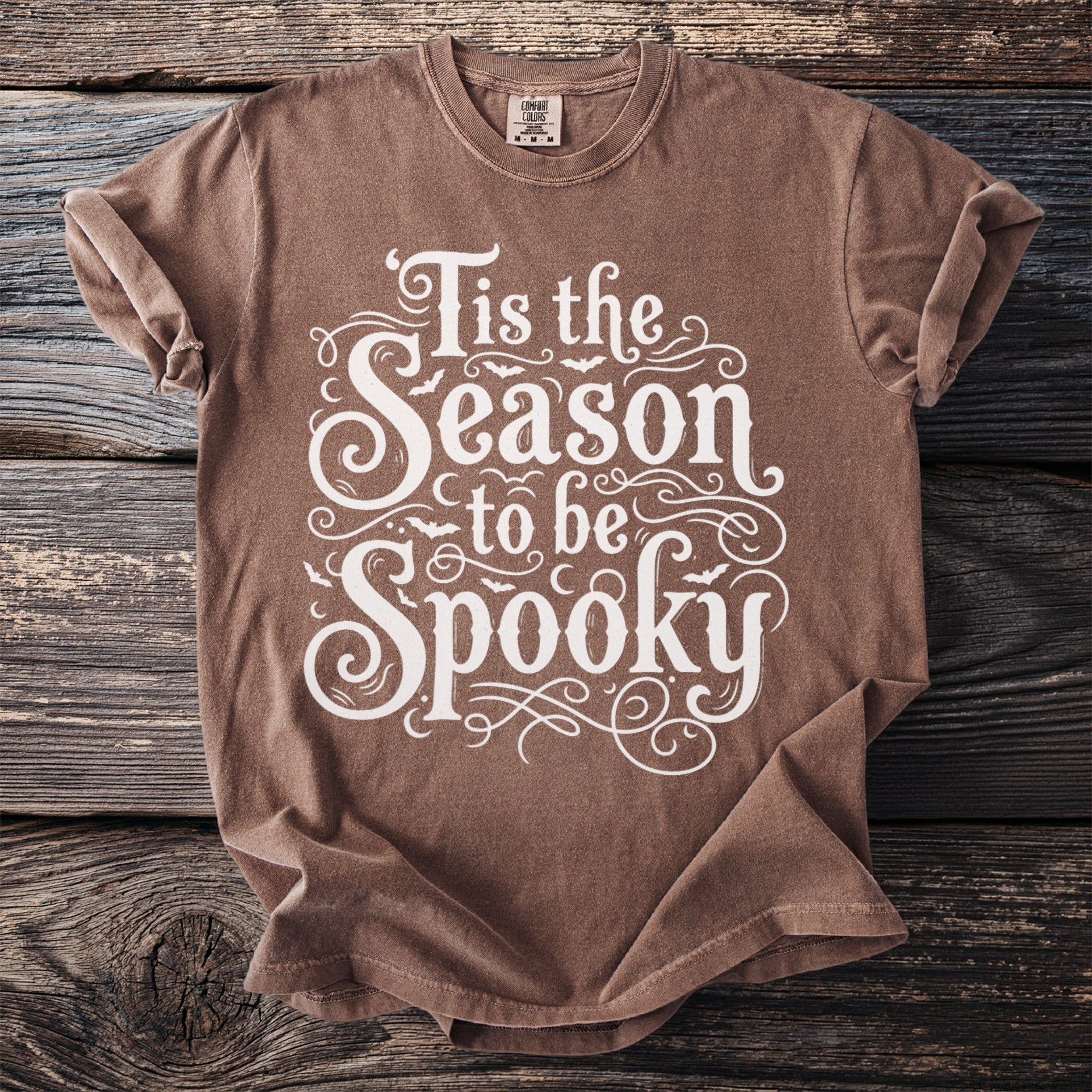Brown t-shirt with white text "Tis the Season to be Spooky" and bat graphics.