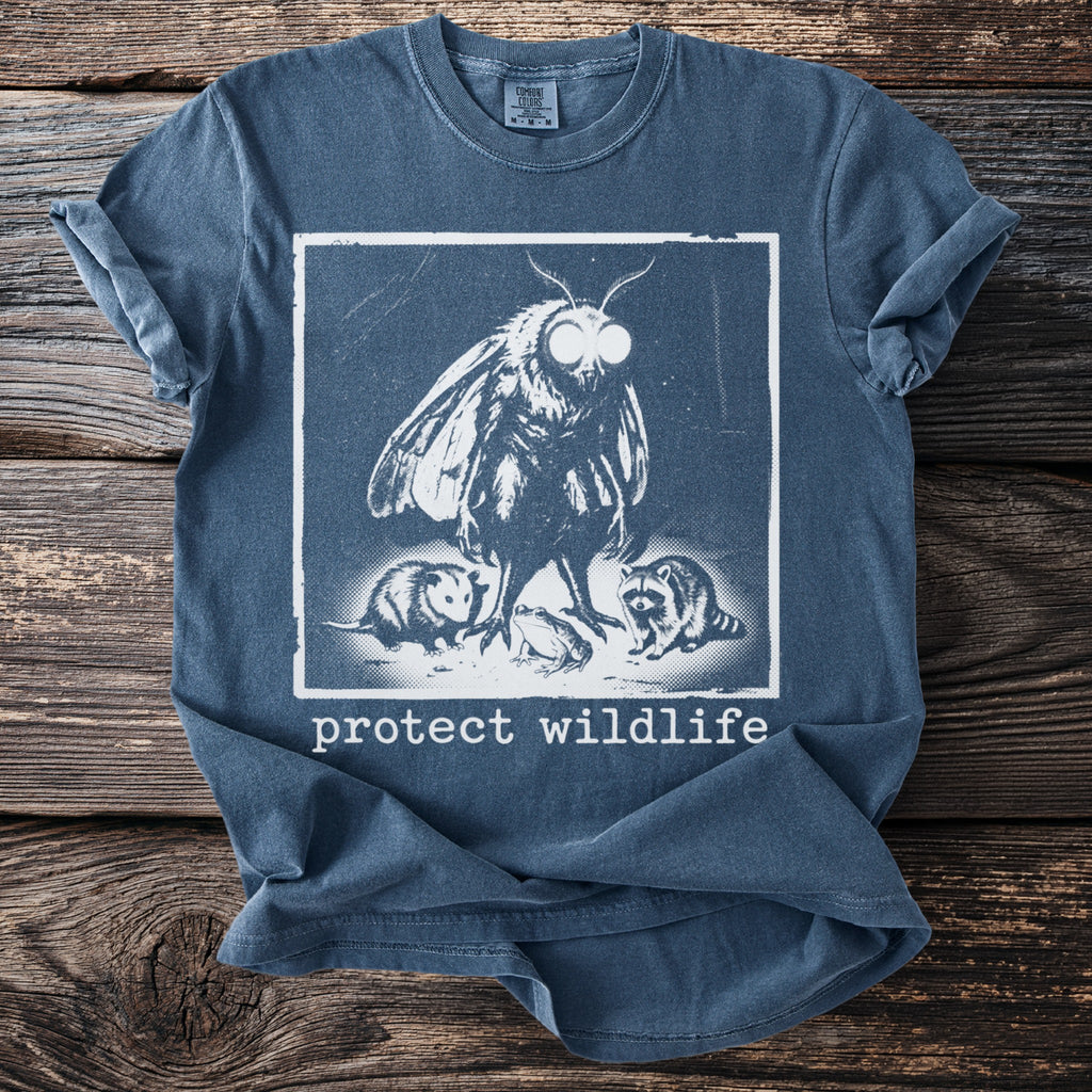 Blue t-shirt with a moth, opossum, frog, and raccoon graphic and "protect wildlife" text.