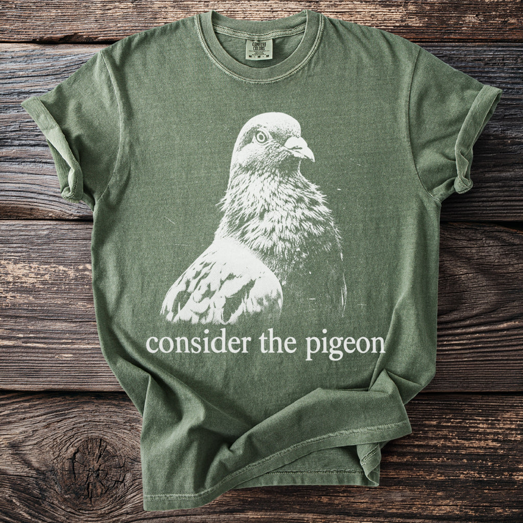 Olive Comfort Colors t-shirt with white pigeon graphic and "consider the pigeon" text.
