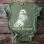 Olive Comfort Colors t-shirt with white pigeon graphic and "consider the pigeon" text.