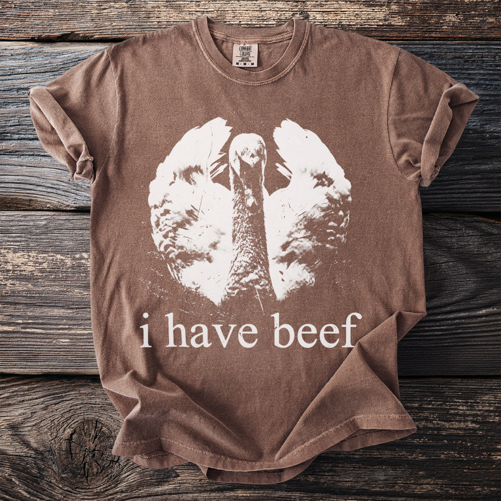 Brown t-shirt with white turkey graphic and "i have beef" text.