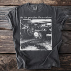 Dark t-shirt with "do not perceive the creature" and a possum under a car.