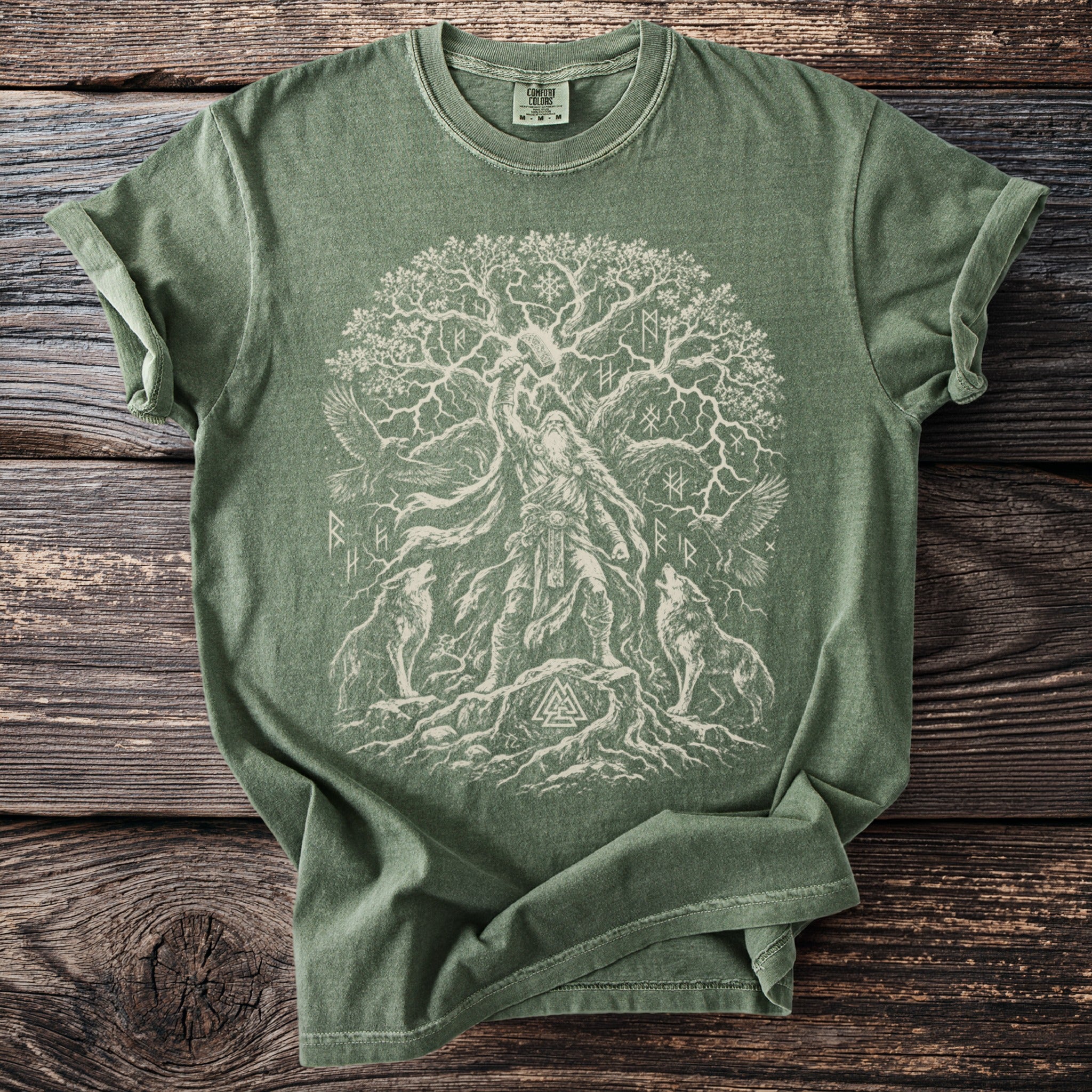Green t-shirt with Norse Yggdrasil tree, Odin, wolves, and runes design.