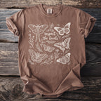 Brown t-shirt with white line art illustration of moths, butterflies, and floral elements, with "respect the locals" text.
