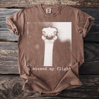 Brown t-shirt with ostrich graphic and text "i missed my flight".