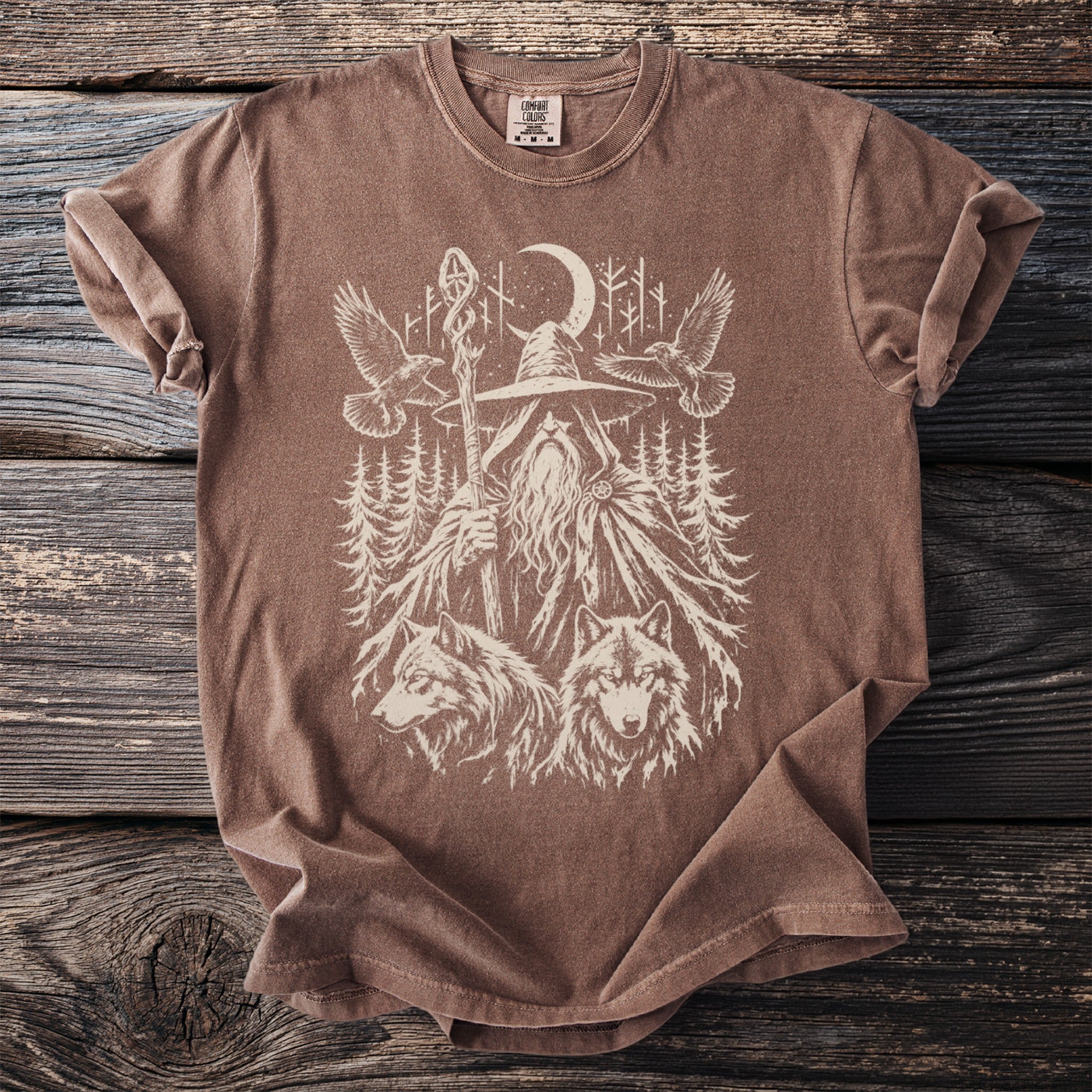 Brown t-shirt with mystical graphic of a wizard, wolves, eagles, and moonlit forest.