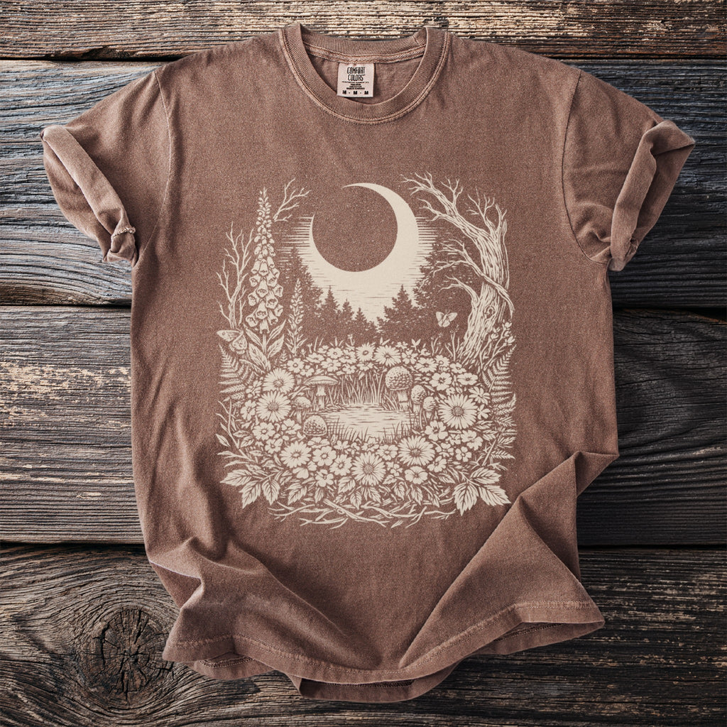 Brown t-shirt with a celestial forest scene graphic in cream.