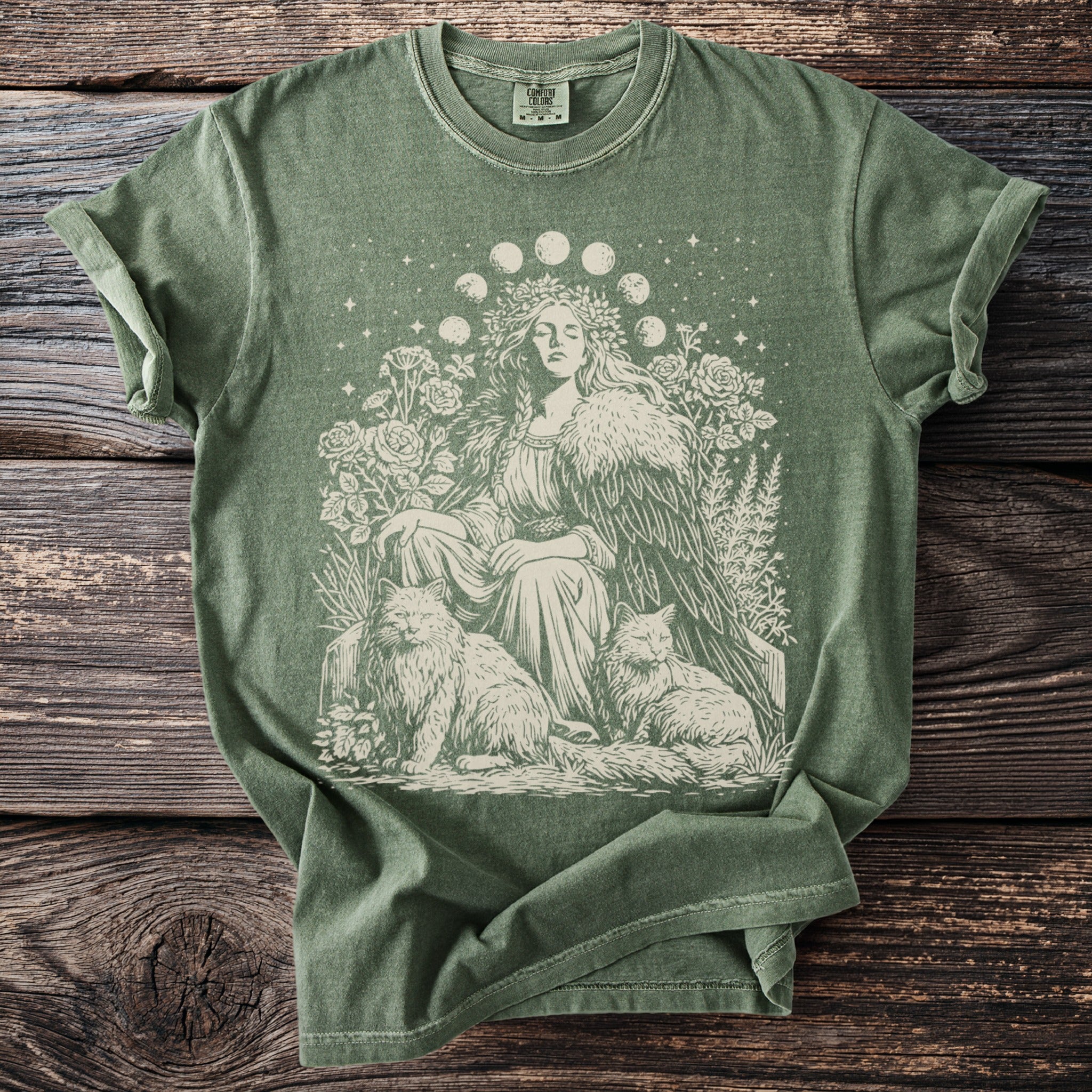 Green t-shirt with a mystical woman, moon phases, cats, and floral print.