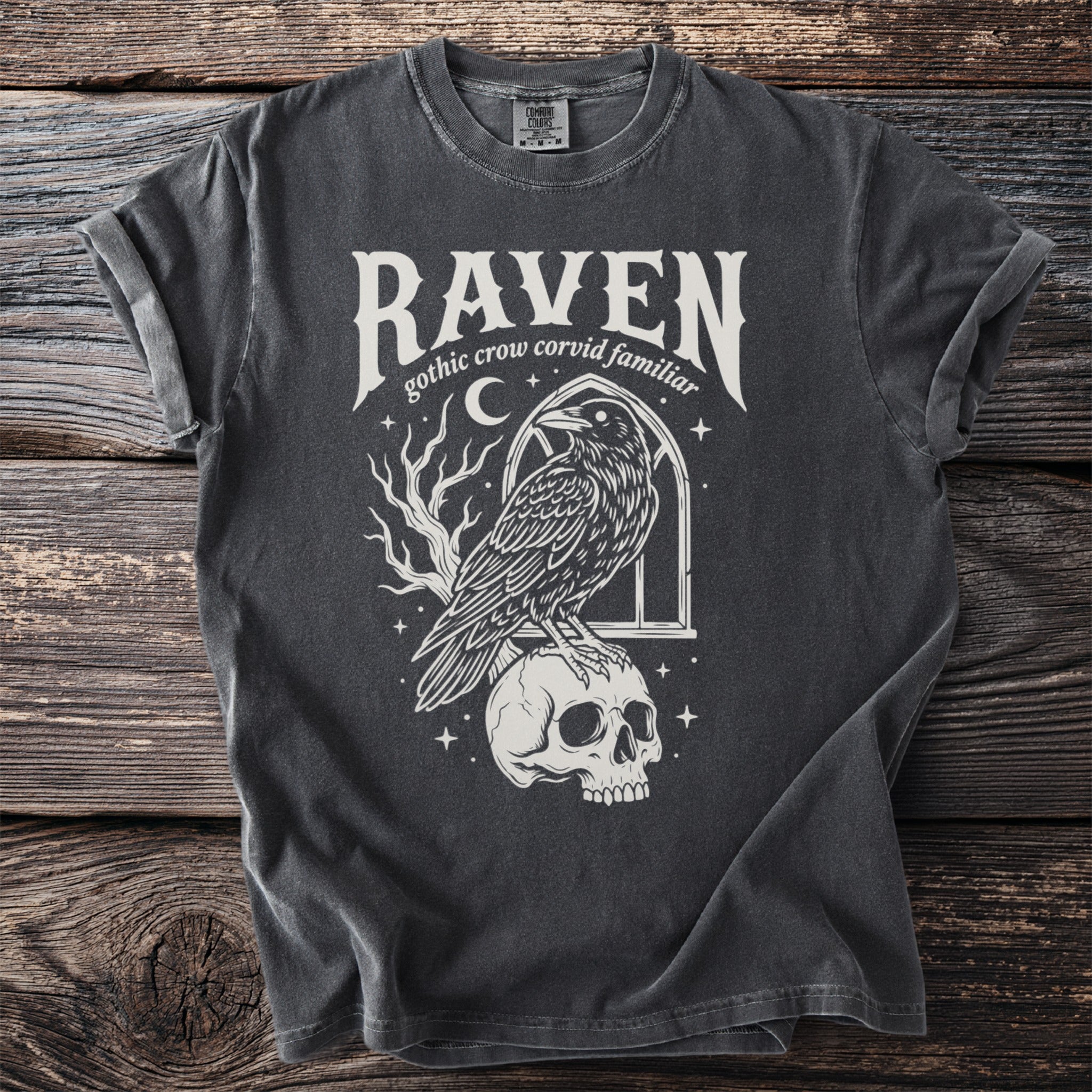 T-shirt with "Raven gothic crow corvid familiar" text and a raven on a skull.
