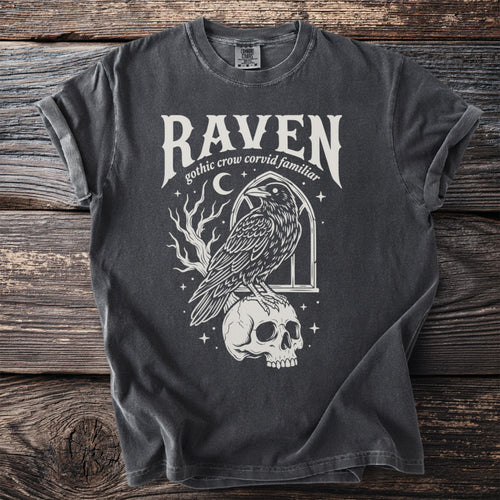 T-shirt with "Raven gothic crow corvid familiar" text and a raven on a skull.