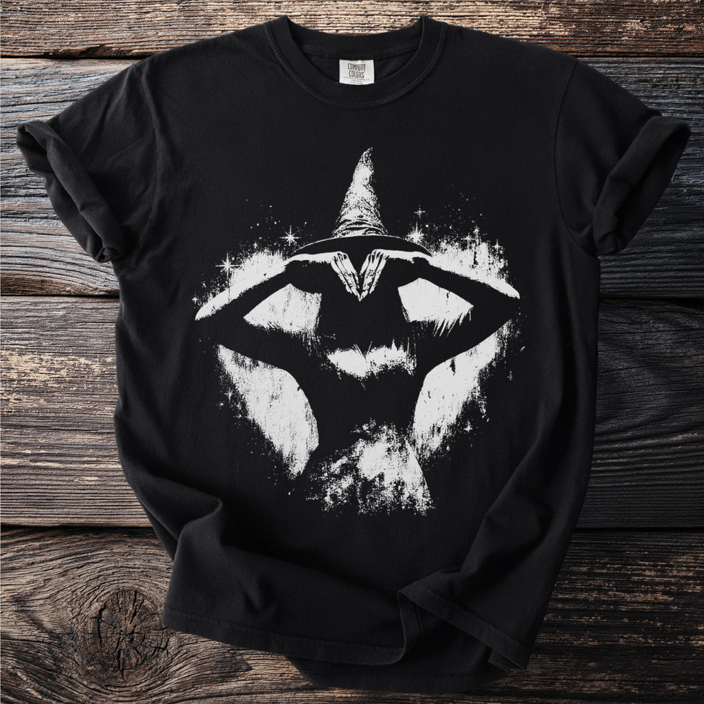Black t-shirt with a white grunge graphic of a witch with a conical hat.