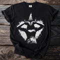 Black t-shirt with a white grunge graphic of a witch with a conical hat.