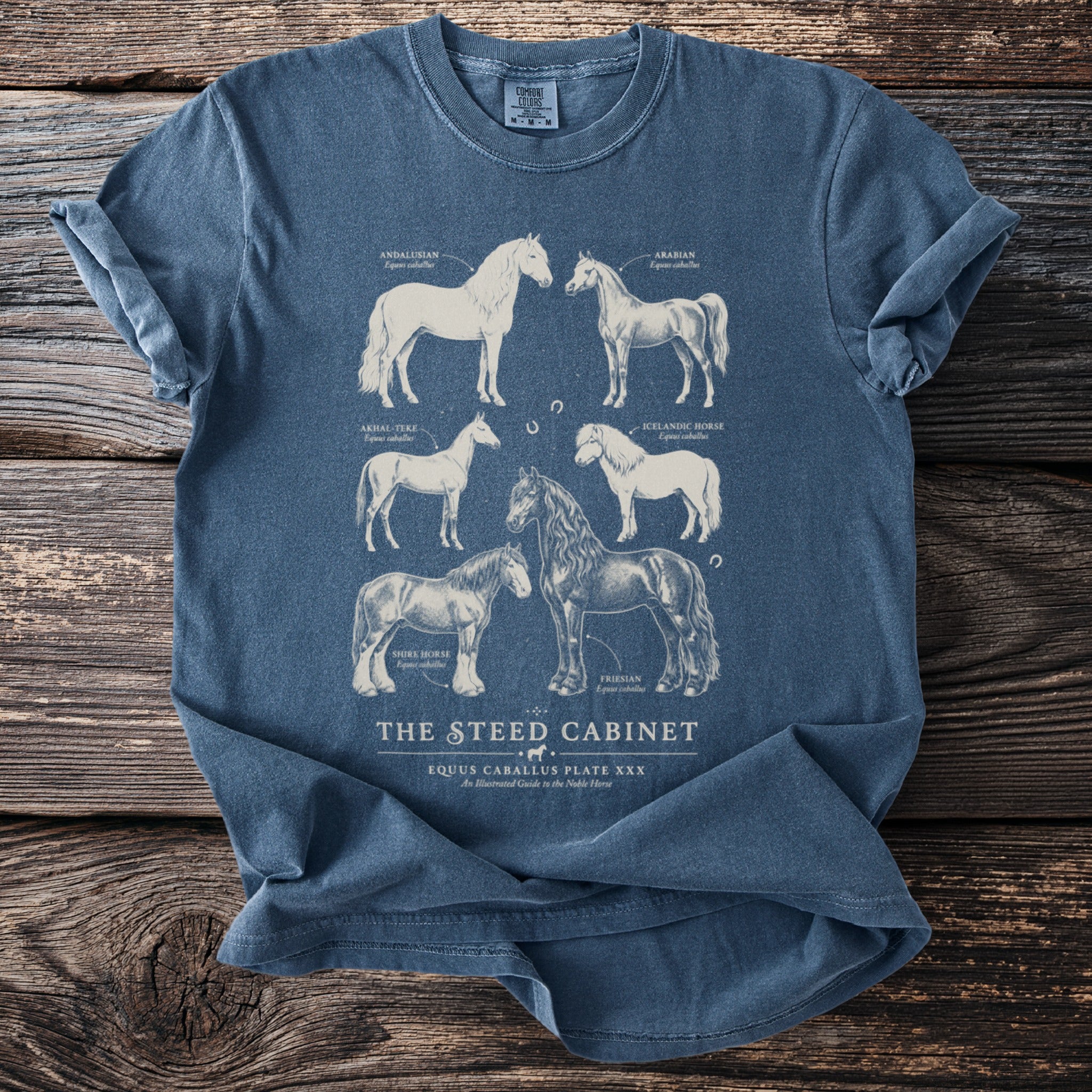 Blue t-shirt with illustrations of six horse breeds, including their names.